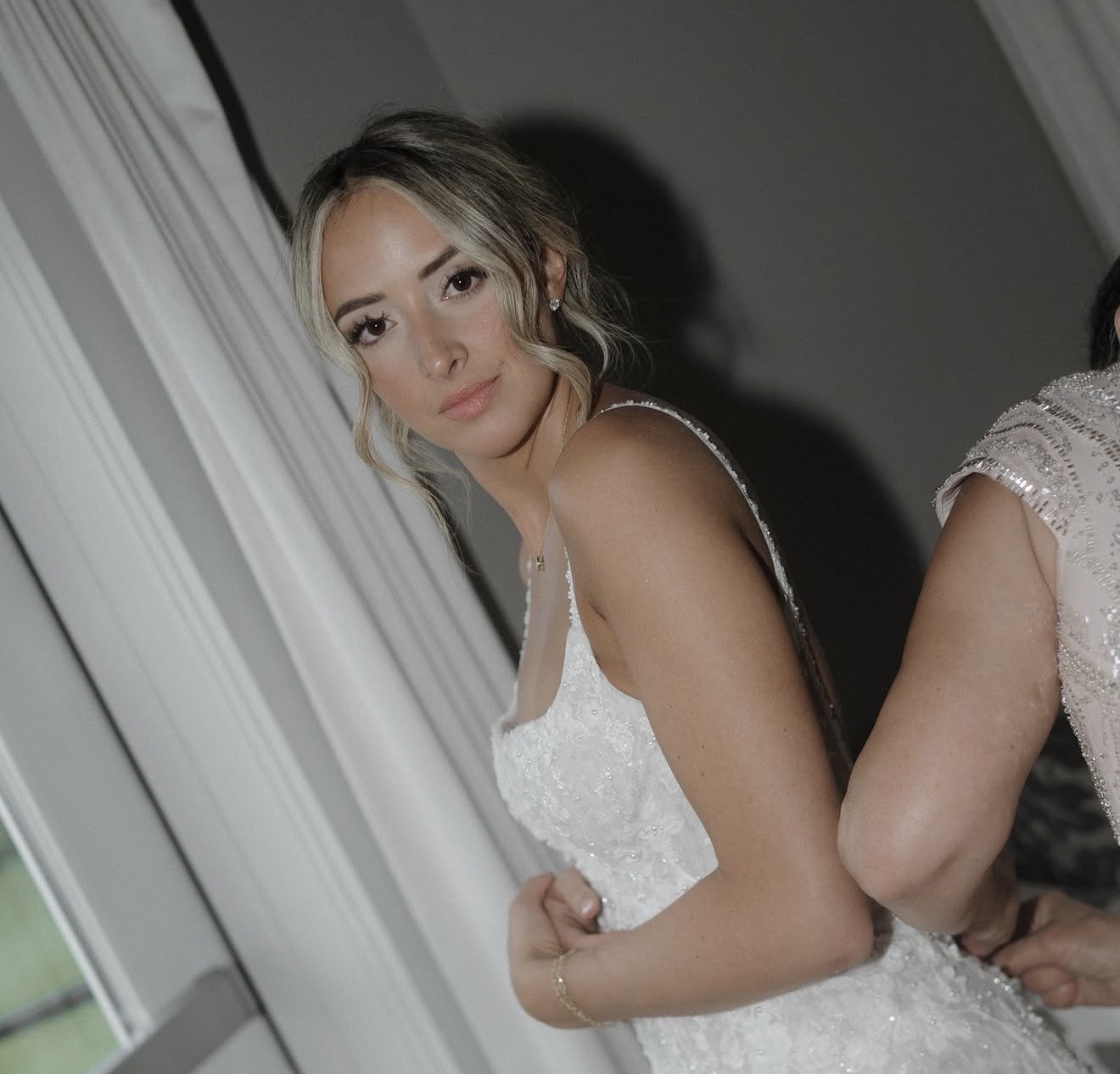 Bride in lace gown with soft romantic makeup